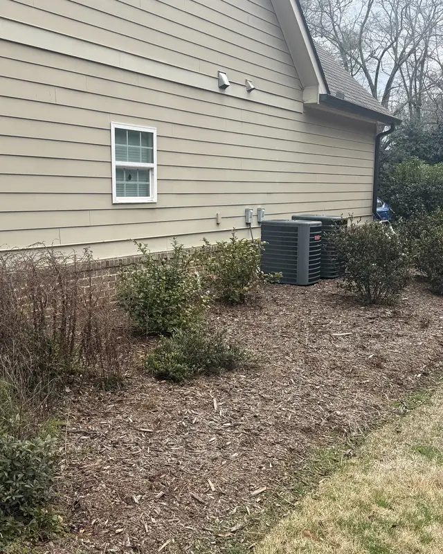 Before: the same side beds with old, faded mulch